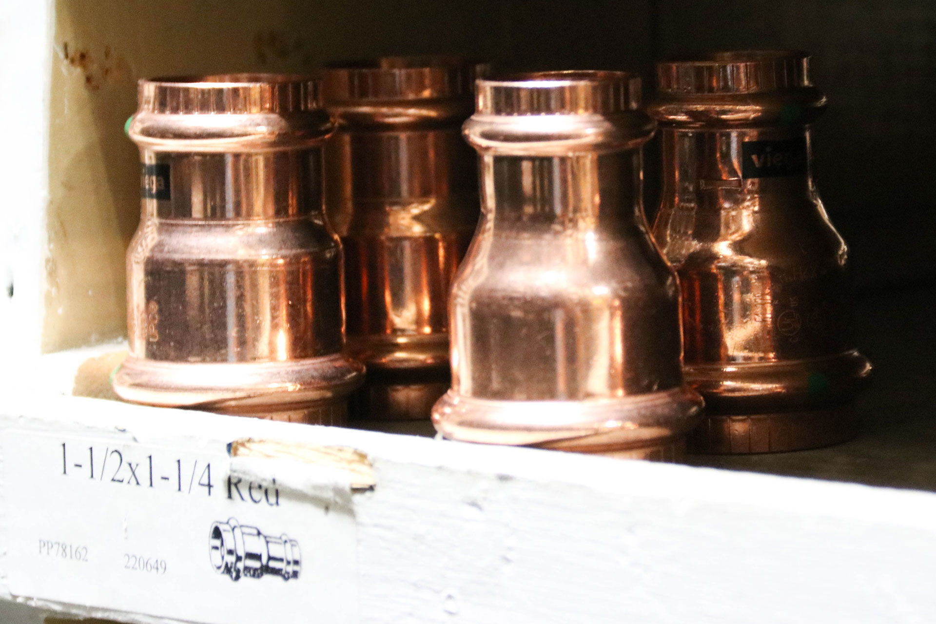 Copper pipe fittings in a box.