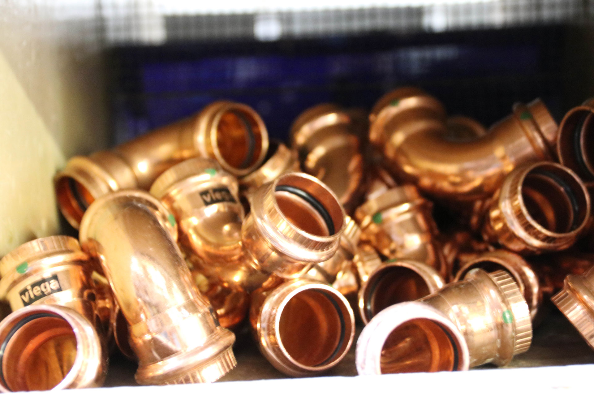 Copper pipe fittings in a box.