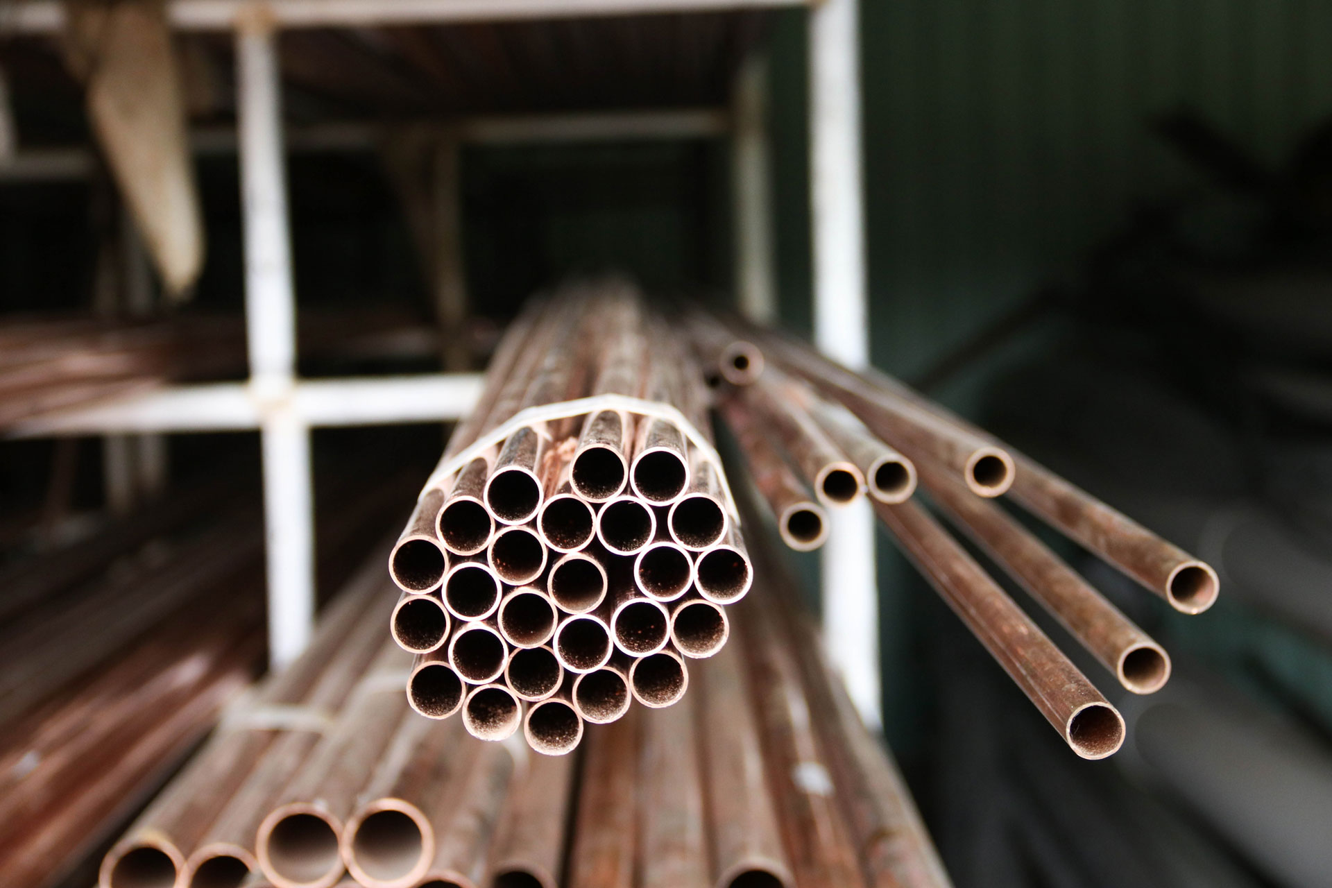 Bundle of copper pipes in storage.