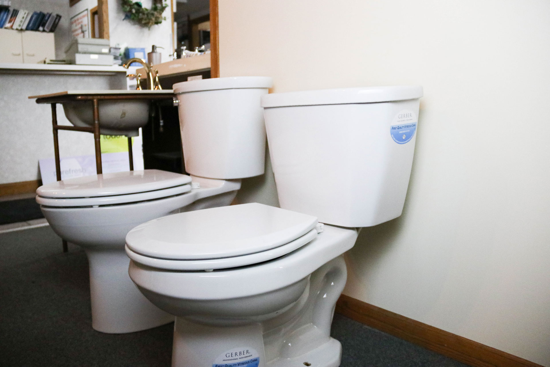 Two white Gerber toilets on display.